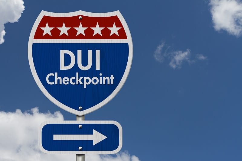 road sign indicating DUI checkpoint up ahead
